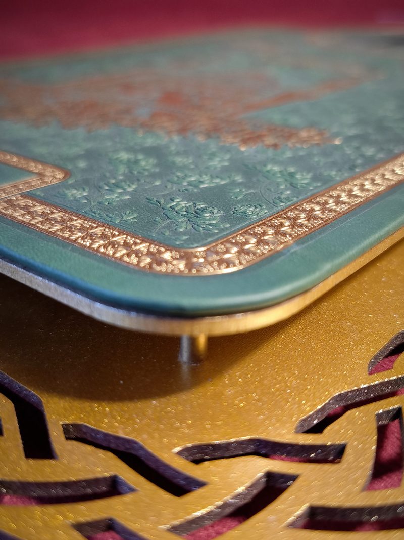 Detail of the gilded border and blind embossing on the wall clock