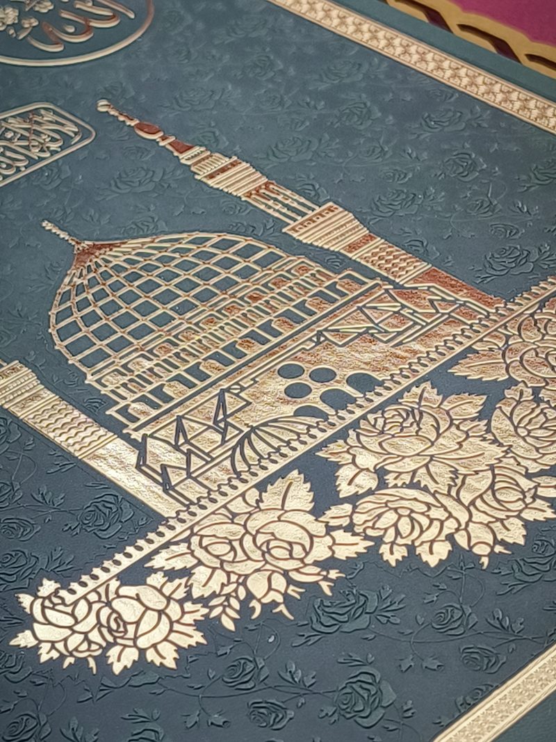 Macro of gold-foiled mosque motif on the leather wall clock