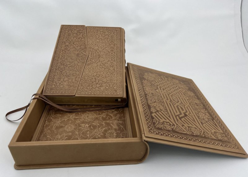 Open leather clamshell traycase with matching embossed volume