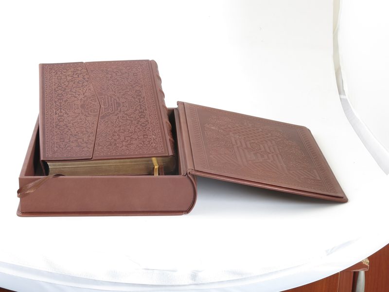 Open brown leather clamshell traycase with its embossed volume