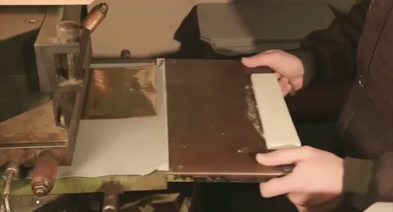 Feeding a stamping plate into the hand-operated hot-foil press